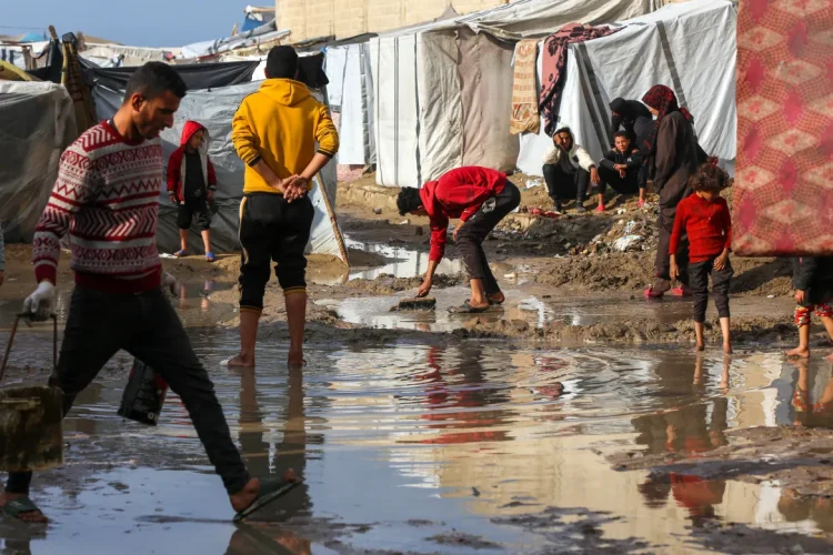 Palestinezët që strehohen në kampet e tendave po luftojnë me kushtet e motit pasi reshjet dendura kanë përmbytur tendat në Deir el-Balah të hënën [Ashraf Amra/Anadolu]